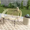 An outdoor seating area with a rattan bench and a side table. Anteprima dell’immagine prodotto