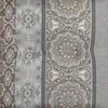 A close-up view of a patterned fabric with mandala-like designs and geometric patterns in shades of gray and tan. Produktbild-Vorschau