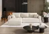 A modern living room with a sectional sofa, fireplace, and coffee tables. Voir les images du produit
