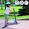 A child is riding a blue scooter in a park. Náhľad obrázku produktu