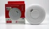 A smoke detector and its packaging are displayed against a white background. Produktbild-Vorschau