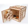A wooden 3D puzzle safe with its door open, revealing coins, a key, and a credit card inside. Produktbild-Vorschau