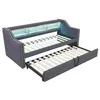 A dark gray upholstered daybed with a pull-out trundle bed is shown against a white background. The daybed has a built-in shelf with LED lighting. Voir les images du produit