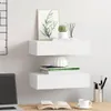 Two white floating shelves mounted on a white wall above a wooden desk. Produktbild-Vorschau