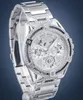 A silver Guess watch with crystal embellishments is displayed against a blue background. Voir les images du produit