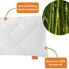 A close-up of a white quilted pillow with text overlays and a circular inset image of bamboo stalks. Produktbild-Vorschau