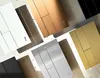 A collection of light switch plates in various finishes arranged diagonally on a textured surface. Produktbild-Vorschau