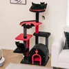 A Halloween-themed cat tree with two black cats on it, placed in a living room setting next to a white couch. Produktbild-Vorschau