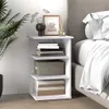 A white bedside table with shelves next to a bed. Voir les images du produit