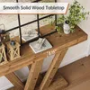 A close-up view of a wooden console table with decorative lanterns and a plant. Podgląd zdjęcia produktu