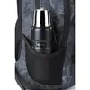 A close-up view of a black thermos bottle with a silver top, branded "THERMOS", placed in the side mesh pocket of a black and gray camouflage-patterned backpack. Produktbild-Vorschau