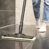 A person is using a steam cleaner on a tiled floor. Produktbild-Vorschau