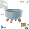 A light gray planter with wooden legs is shown with dimensions and capacity indicated. Náhľad obrázku produktu