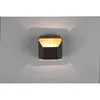 A modern black and wood wall light is mounted on a light gray wall, casting light upwards and downwards. Podgląd zdjęcia produktu