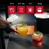 A person adding ice to two cocktails. Podgląd zdjęcia produktu