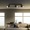 A modern living room with a ceiling light fixture, dining table, and sofa. Produktbild-Vorschau