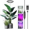 A large plant is shown with a ring-shaped LED grow light above it. Smaller inset images show the light in different modes and colors, along with its power adapter and controller. Náhľad obrázku produktu