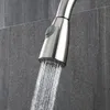 A close-up shot of a kitchen faucet spraying water against a tiled wall. Náhľad obrázku produktu