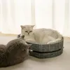Two cats interacting near a cat bed. Produktbild-Vorschau