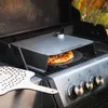 A pizza is being cooked on a gas grill using a pizza oven attachment. Podgląd zdjęcia produktu