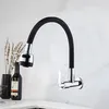 A kitchen faucet with a flexible black hose is mounted on a marble-patterned wall. Náhľad obrázku produktu