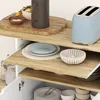 A kitchen cart with various kitchen items on its shelves. Podgląd zdjęcia produktu