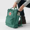 A person is putting a water bottle into the side pocket of a green backpack. Náhled obrázku produktu