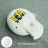 Close-up view of a battery compartment for a decorative light, showing batteries and a switch. Produktbild-Vorschau