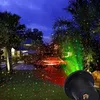 A garden at night illuminated by a red and green laser light projector. Anteprima dell’immagine prodotto