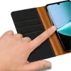 A hand is touching a smartphone inside a flip case. Voir les images du produit