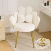 A white velvet chair with a bow-shaped pillow and gold legs, placed on a rug next to a dresser. Náhľad obrázku produktu
