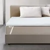 A mattress topper on a bed with pillows. Produktbild-Vorschau