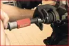 A person is using a tool to compress a brake caliper piston. Náhled obrázku produktu