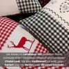 A close-up view of several decorative pillows with a rustic, country-style design. Produktbild-Vorschau