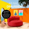 A red beanbag chair on a sandy beach with palm trees and tropical artwork in the background. Produktbild-Vorschau