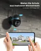 A security camera mounted on a brick wall, with a smartphone displaying its live feed in the foreground. Produktbild-Vorschau