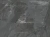 A close-up view of dark gray marble-patterned vinyl flooring tiles. Produktbild-Vorschau
