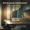A desk with two monitors mounted on a stand, in a well-lit room with curtains. Produktbild-Vorschau