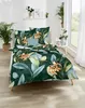 A bedroom scene with a bed dressed in floral bedding, plants, and decorative items on a shelf. Produktbild-Vorschau