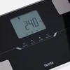 A close-up view of a black digital scale's display and control buttons. Produktbild-Vorschau