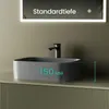 A dark gray ceramic basin is shown on a counter with a black faucet. A mirror with text is above the basin. Produktbild-Vorschau