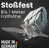 A large rock is breaking apart as it falls onto a sharp surface, illustrating the product's durability. Produktbild-Vorschau