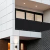 A modern building facade with a balcony featuring a black privacy screen. Podgląd zdjęcia produktu