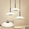 Three modern pendant lights hanging over a table. Anteprima dell’immagine prodotto