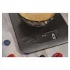 A digital kitchen scale with a bowl of brown sugar on it, set on a wooden surface with a few berries scattered around. Náhľad obrázku produktu