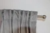 A close-up view of gray curtains hanging from a curtain rod. Produktbild-Vorschau