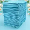 A stack of light blue pet training pads is shown against a blurred background of white flowers and light blue. Náhľad obrázku produktu