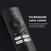 A close-up of a black remote control with various buttons and app logos, set against a dark background. Produktbild-Vorschau