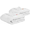 Two white duvets are folded and stacked on a white background. Produktbild-Vorschau