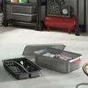 Two storage boxes are shown on a concrete floor, with one open and filled with clothes, and the other containing various tools and accessories. In the background, a red air compressor is visible. Produktbild-Vorschau